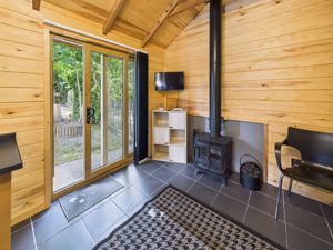 SEATING AREA IN CABIN WITH MULTI-FUEL STOVE- click for photo gallery